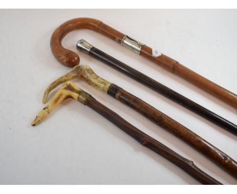 An alder tree walking stick, with an antler handle carved in the form of a dog's head, 86 cm long, other similar canes and wa