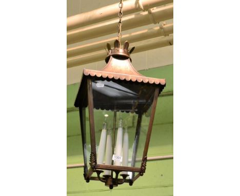 A Victorian style metal lantern with four candle holders 