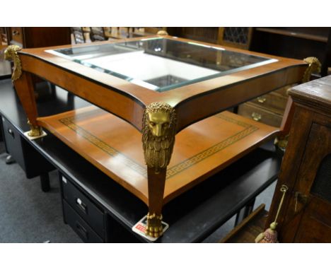 An Egyptian revival burr maple, ebony and gilt metal mounted coffee table, modern, with plate glass top above a shelf with a 