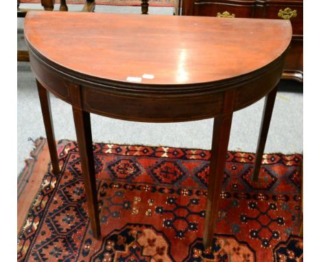 A George III inlaid mahogany demi lune fold over card table 