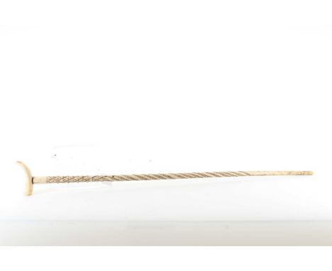 VICTORIAN CARVED WHALE BONE WALKINGSTICK, MID TO LATE-19TH CENTURY with sperm whale tooth handle, the tapered shaft with cheq