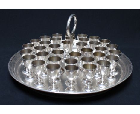 A white-metal Holy Communion set, comprising thirty-six small wine cups on circular stand with carry handle (great for shots!