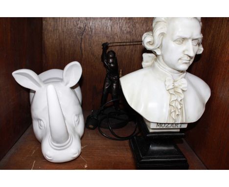 SECTION  43. A white pottery Rhinos head, a resin bust of Mozart and a resin golfing lamp. (3)