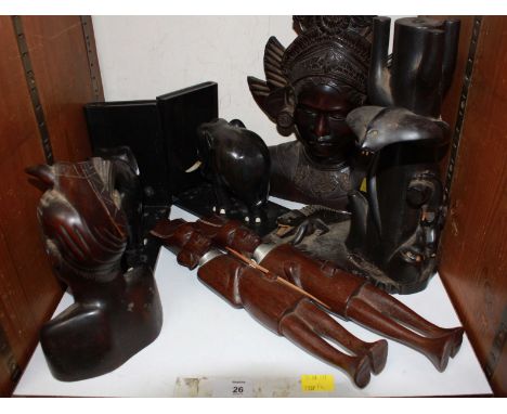 SECTION 26. A collection of carved hardwood tribal figures, including a Ceylon elephant and cobra tree trunk group, an Indone