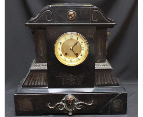 A Victorian heavy black slate mantle clock, of architectural form, with gilt dial and white enamel chapter ring, with ormolu 