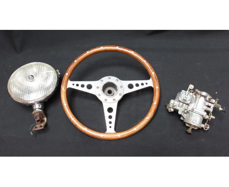 A vintage Moto Lita wood and aluminium steering wheel, together with a Ford carburettor and a Lucas chrome spot light. (3)