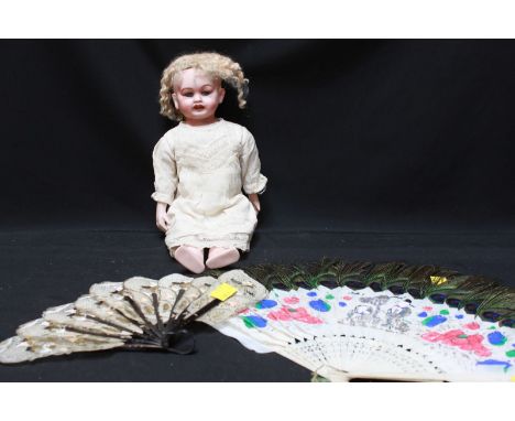 A 'Goss' bisque headed doll, with bisque hands and arms; together with two Oriental fans (3).