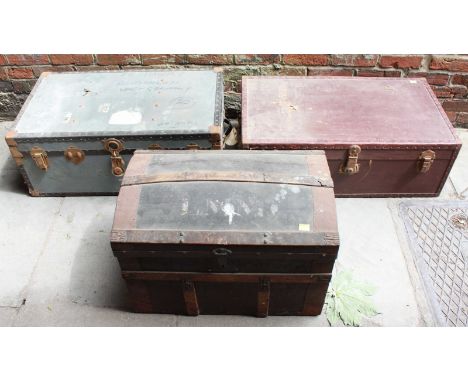 A brown vinyl trunk, similar-sized metal trunk, and a dome-top trunk.  