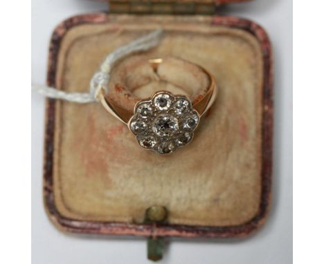 A 18ct gold diamond cluster ring, set with  nine diamonds in a rub-over "flower" setting, estimated total diamond weight 1.00