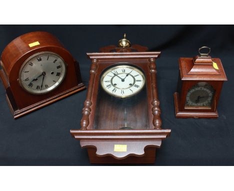 Two mahogany mantel clocks together with a wall clock.