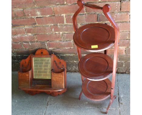 A Victorian oak wall shelf with mirror and pockets, stamped with Rd. No. for 1892; together with an Edwardian mahogany cake s