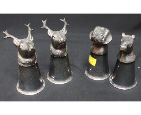 A set of four silver plated stirrup cups, two stags, a horse’s head and fox hound.