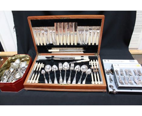 A silver plated canteen of cutlery in a wooden case, a quantity of loose silver plated cutlery and a modern silver caddy spoo