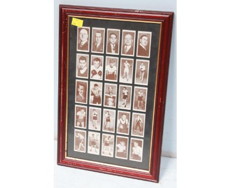 A framed set of 25 Churchman cigarette cards of early 20th century boxers and boxing personalities, glazed back and front.  