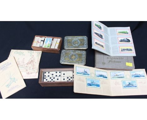 Two Queen Mary 1914 Christmas tins, together with a boxed set of ebony and bone dominoes and a collection of cigarette cards.