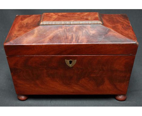 A 19th century mahogany sarcophagus shaped tea caddy, with two internal lidded compartments. 22.5 cm wide.