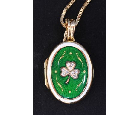 A Faberge 18ct gold, diamond and enamel oval locket on chain, the front decorated with a shamrock, each leaf set with diamond