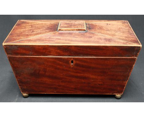 A 19th century mahogany sarcophagus shaped tea caddy, with two internal lidded compartments and central circular well support