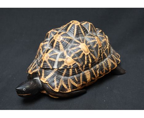 A novelty tortoise shell and ebony trinket box, with hinged shell and fitted inside with a lidded compartment and parquetry i