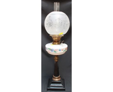 A Victorian brass oil lamp, with etched glass shade, opaque painted glass reservoir and supported on a fluted and tapering co