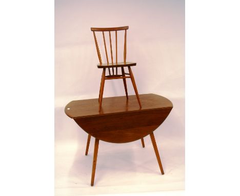 A light Ercol drop leaf dining table, 71cm high, 113cm x 127cm extended; and a set of six similar stick back chairs, 78cm hig