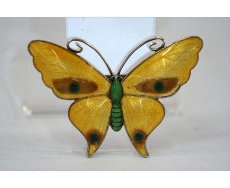 A Sterling silver and enamel brooch, in the form of a butterfly, marked verso, Sterling Silver J.A. & S. 2577, 6cm x 5cm in e
