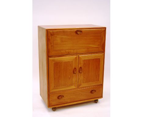 A light Ercol bureau, with drop front door enclosing fitted interior above further cupboard doors and single drawer below, 11