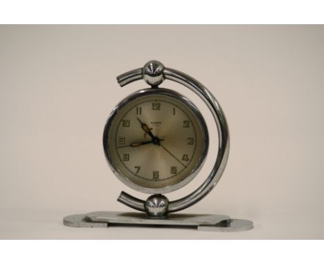 An Art Deco chrome cased eight day alarm clock of circular form