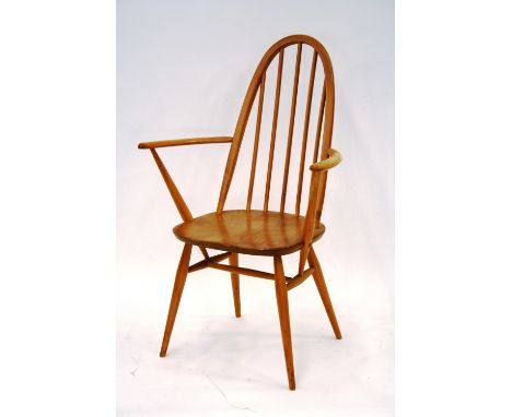 A set of four light Ercol stick back chairs, two standards, two carvers, 96cm high 