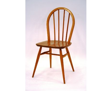 A set of four light Ercol stick back chairs, 85cm 