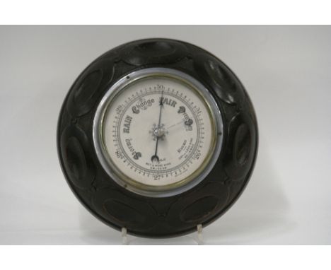 A 1920's oak cased circular barometer, 23cm dia. 