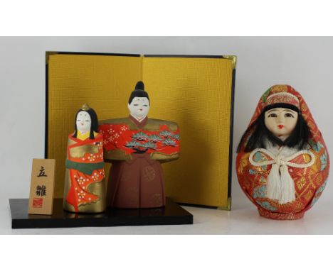 Japanese round doll with fabric covering and a Japanese ceramic man & wife on stand 