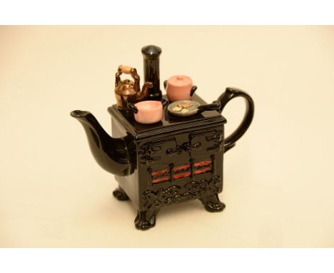 A collectors ceramic teapot formed as an Aga  