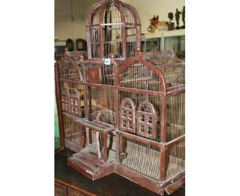 A VINTAGE PAINTED WOOD AND WIREWORK BIRDCAGE