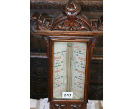 A VICTORIAN CARVED OAK CASED STICK BAROMETER