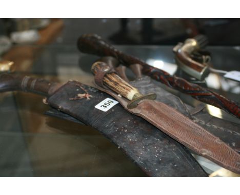 TWO VINTAGE KUKRI, A SHEATH KNIFE AND A CARVED WOOD STAFF