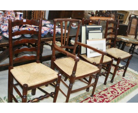 A SET OF FOUR RUSH SEAT LADDER BACK CHAIRS AND A SIMILAR ARMCHAIR