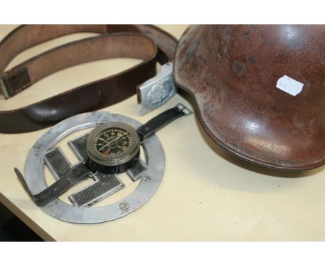 A NAZI MILITARY HELMET, A GERMAN WRIST COMPASS, BELT,ETC