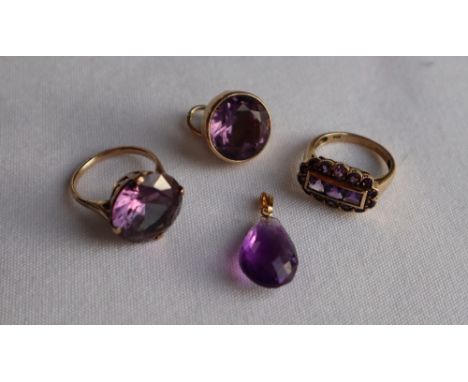 A 9ct yellow gold amethyst set dress ring, with three princess cut amethysts surrounded by fourteen round faceted amethysts, 