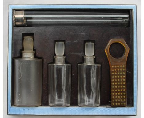 A George V silver, blue enamel and bakelite travelling dressing table set, comprising a tall silver topped and glass vial, th