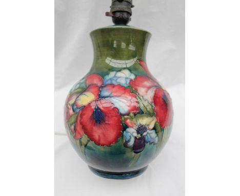 A Moorcroft pottery table lamp of baluster form, decorated in the orchid pattern to a green ground, impressed signature, init