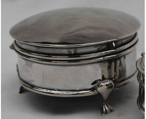 A silver trinket box of circular plain form with moulded borders, on three trefoil supports, marks worn, 9cm diameter