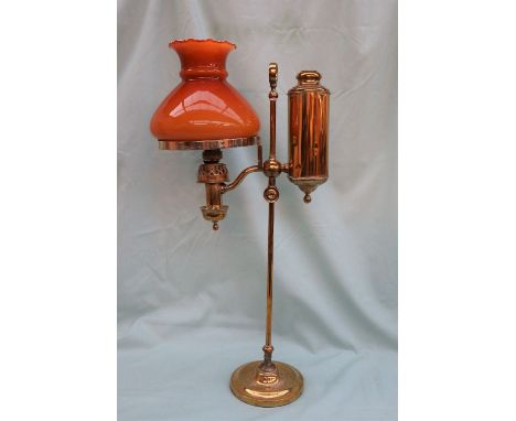 A Brass and glass oil lamp, with an orange glass shade and brass column on a spreading foot, 57cm high  CONDITION REPORT: Sha