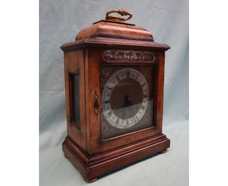 A 20th century walnut cased bracket clock in the George III style, the caddy top above a brass and silvered dial with female 