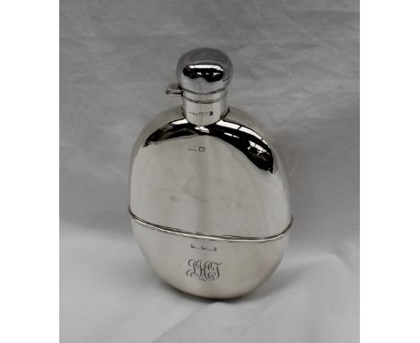 A George V silver oval hip flask, with a captive top and cup base with monogram, Sheffield, 1924, Walker &amp; Hall, 17cm hig