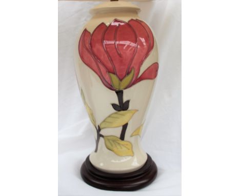 A Moorcroft "Magnolia" pattern pottery table lamp, in cream, of baluster form, 27cm high not including base and shade