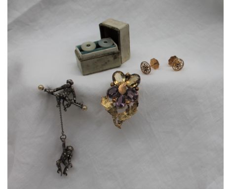 A citrine and amethyst brooch, set with three oval faceted amethyst and two citrines of floral form with falling leaf surmoun