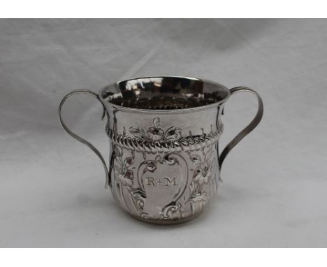 A George III silver two handled cup, with floral embossing, R &amp; M inscribed within rococo cartouche and E M J July 11th 1