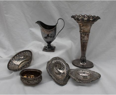 A George III silver helmet shaped cream jug on a pedestal foot and square base, London, 1797, together with a pair of pierced