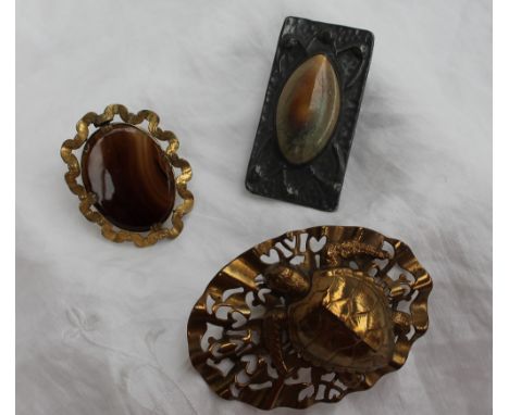A Pewter and pottery brooch, in the Art Nouveau style together with a turtle brooch and banded agate brooch